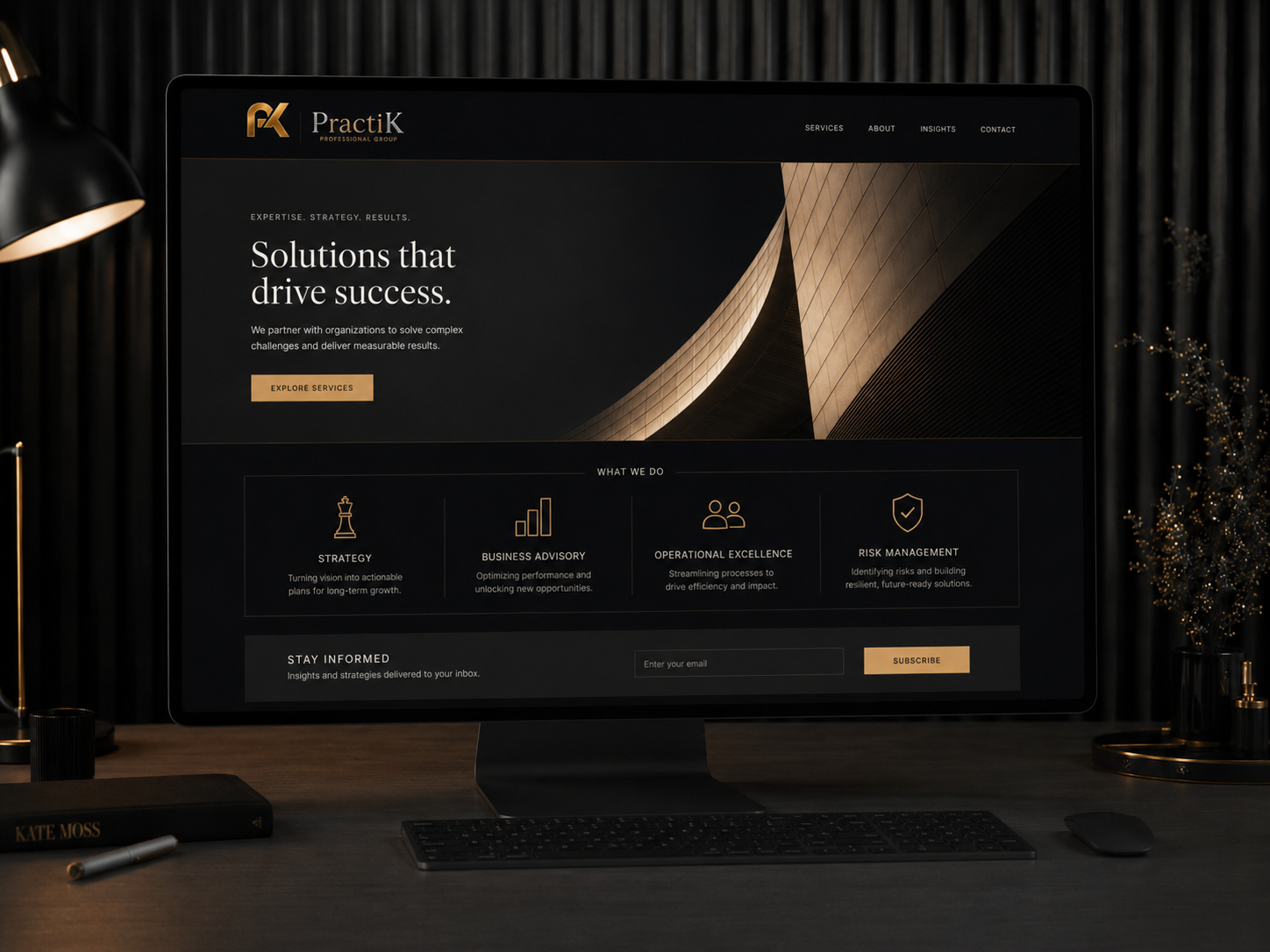 PractiK website design — laptop showing a website mockup with PractiK business card and notebook on a wooden desk